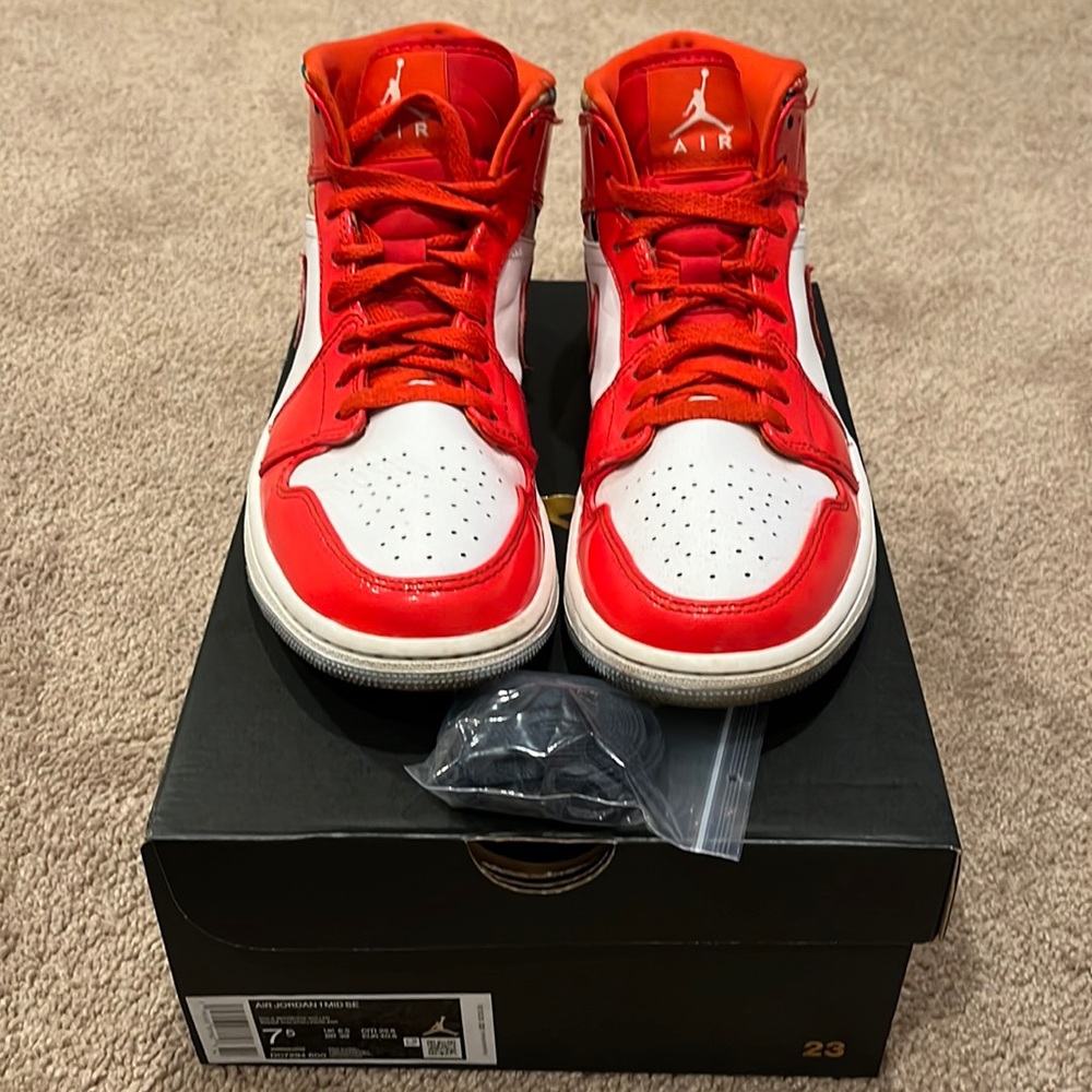 Red and white air Jordan’s, with laces, and the box and wrapping paper.
